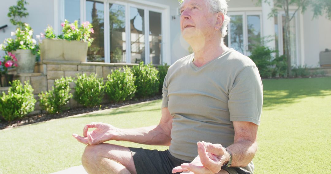 Senior Man Meditating in Garden with Peaceful Expression - Free Images, Stock Photos and Pictures on Pikwizard.com