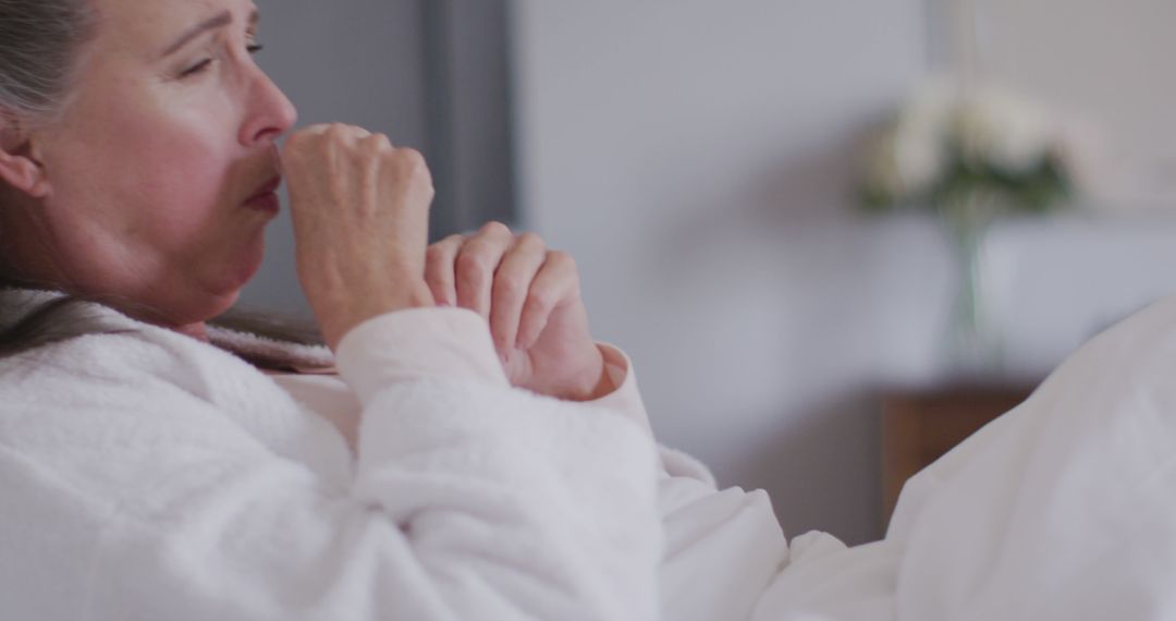 Elderly Woman Coughing in Bed during Illness - Free Images, Stock Photos and Pictures on Pikwizard.com