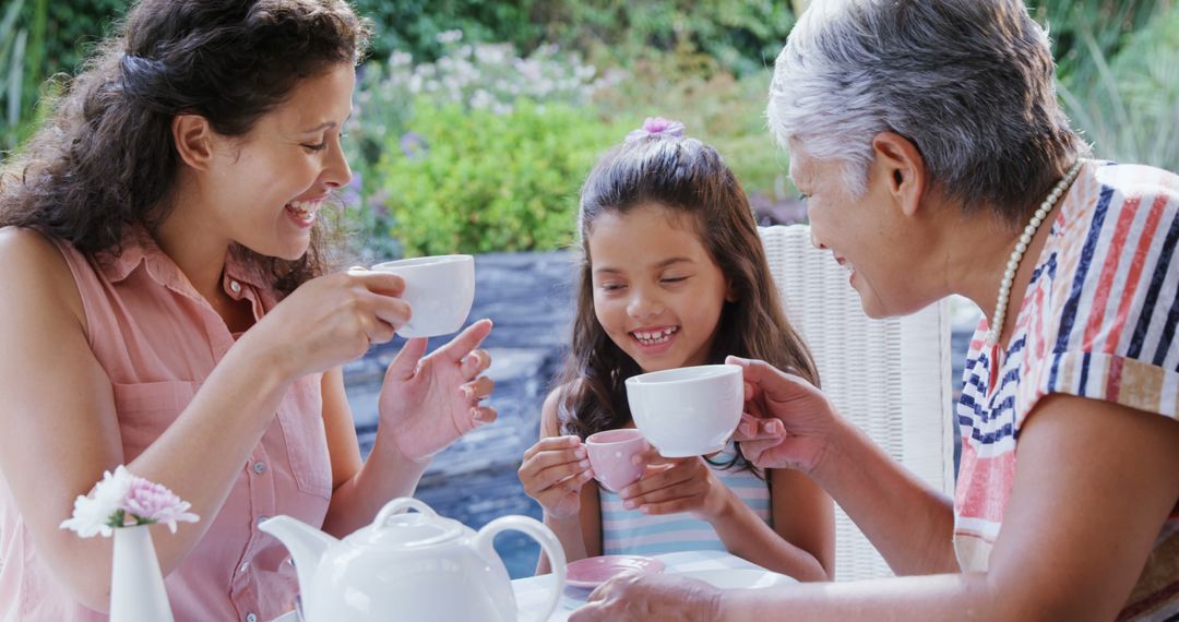 Family Enjoying Tea Time Outdoors in Garden Setting - Free Images, Stock Photos and Pictures on Pikwizard.com