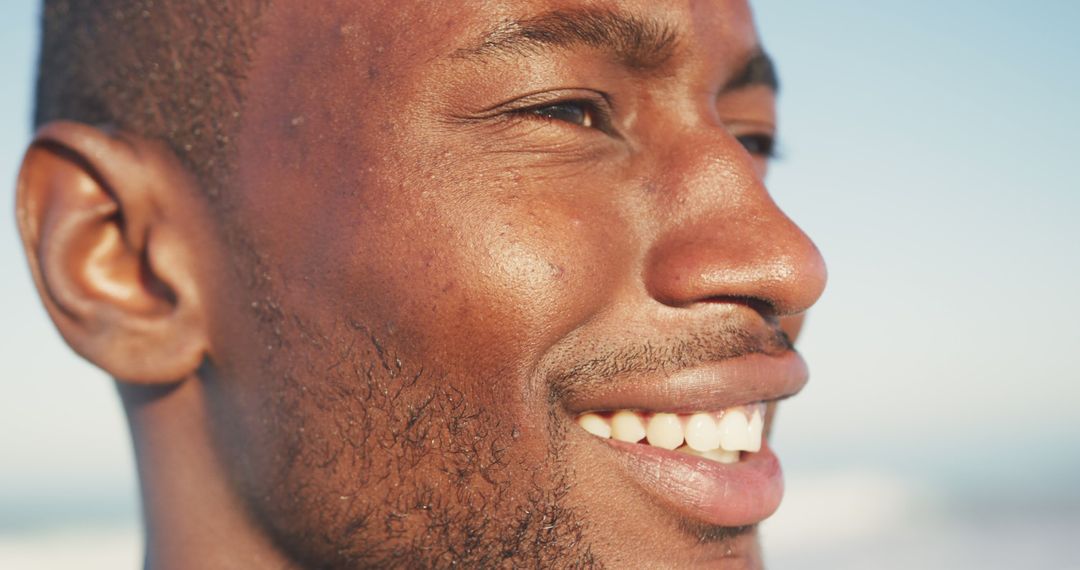 Close-up of smiling African American man enjoying the outdoors - Free Images, Stock Photos and Pictures on Pikwizard.com