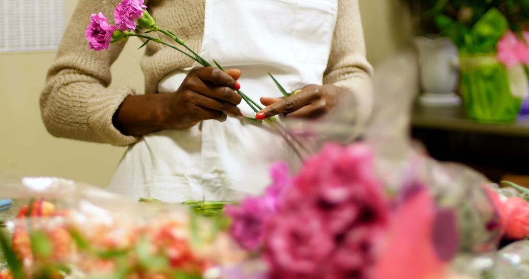 Florist Arranging Pink Carnations at Flower Shop - Free Images, Stock Photos and Pictures on Pikwizard.com