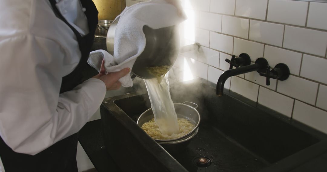 Chef Draining Boiling Pasta Using Sieve Over Sink - Free Images, Stock Photos and Pictures on Pikwizard.com