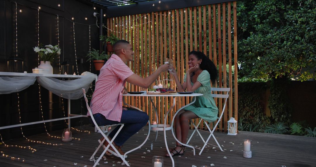Romantic Evening in Garden with Happy Couple Sharing Drinks