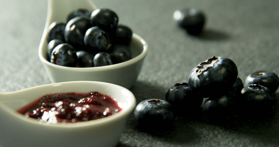 Fresh Blueberries with Jam in White Bowls on Dark Surface - Free Images, Stock Photos and Pictures on Pikwizard.com