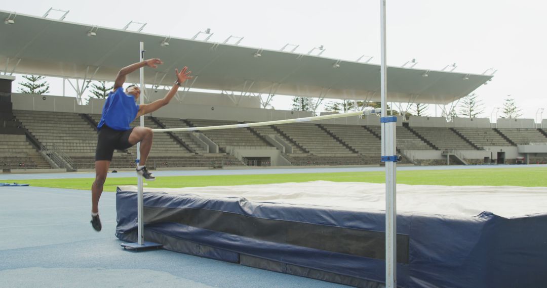 Male Athlete Practicing High Jump at Track and Field Stadium - Free Images, Stock Photos and Pictures on Pikwizard.com