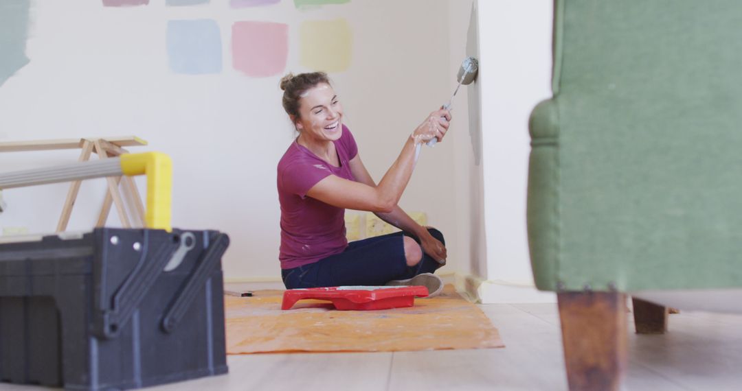 Smiling Woman Painting Wall in Renovated Room - Free Images, Stock Photos and Pictures on Pikwizard.com