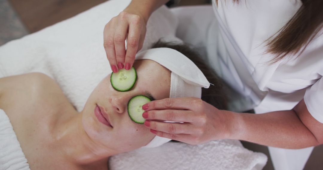 Woman Enjoying Facial Treatment With Cucumber Slices at Spa - Free Images, Stock Photos and Pictures on Pikwizard.com