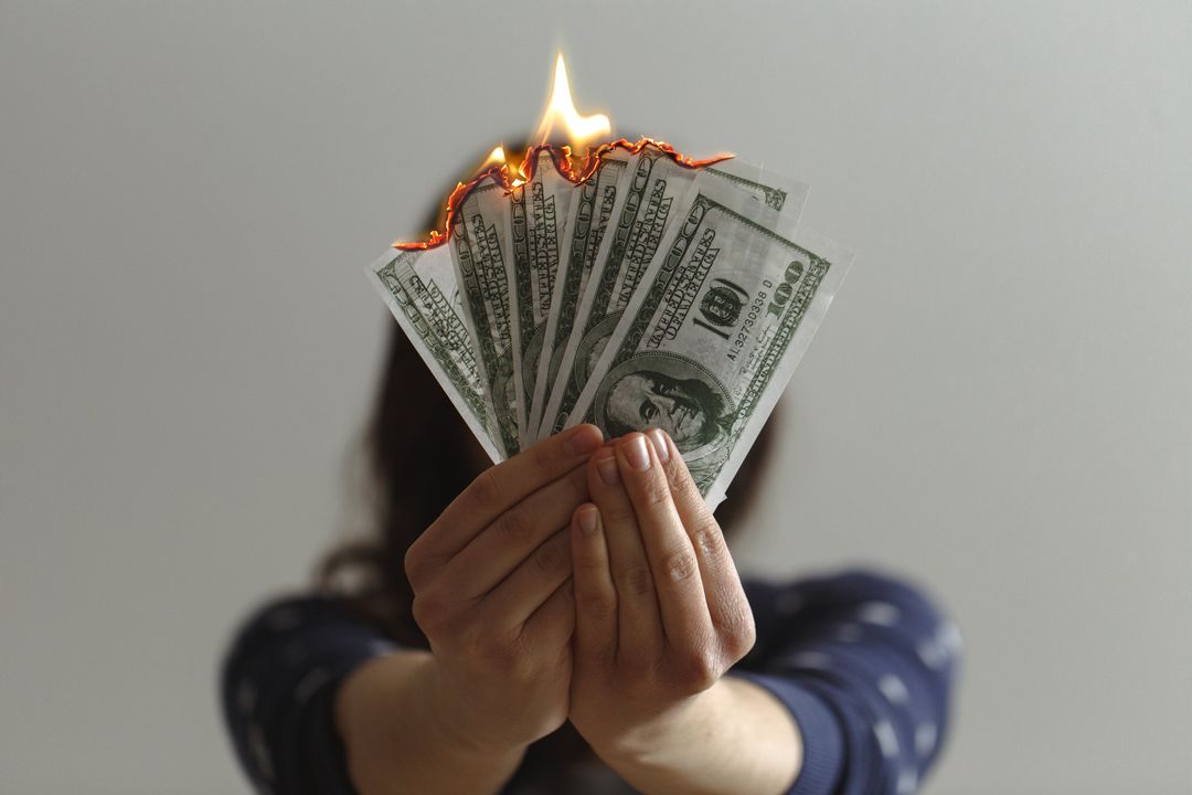 Person Holding Burning Dollar Bills Front View