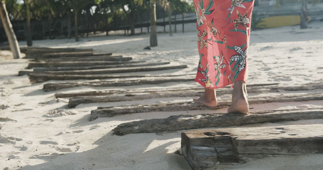 Woman Walking on Wooden Posts on Tropical Beach - Free Images, Stock Photos and Pictures on Pikwizard.com