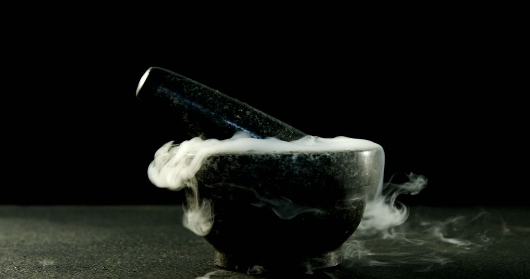 A mortar and pestle emits a mysterious smoke against a dark background, with copy space - Free Images, Stock Photos and Pictures on Pikwizard.com