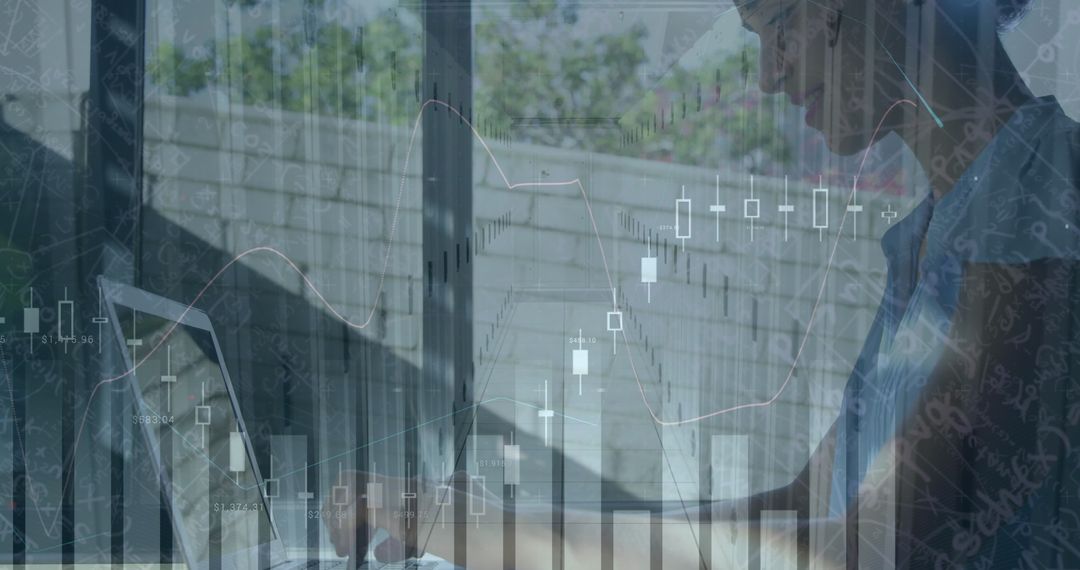 Financial Analyst Reviewing Data and Graphs on Laptop