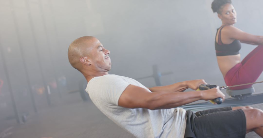 Focused Individuals Exercising on Rowing Machines in Gym - Free Images, Stock Photos and Pictures on Pikwizard.com