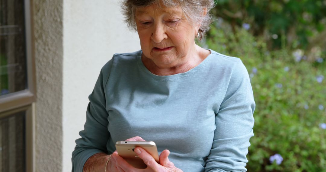 Senior Woman Using Smartphone at Home Outdoors - Free Images, Stock Photos and Pictures on Pikwizard.com