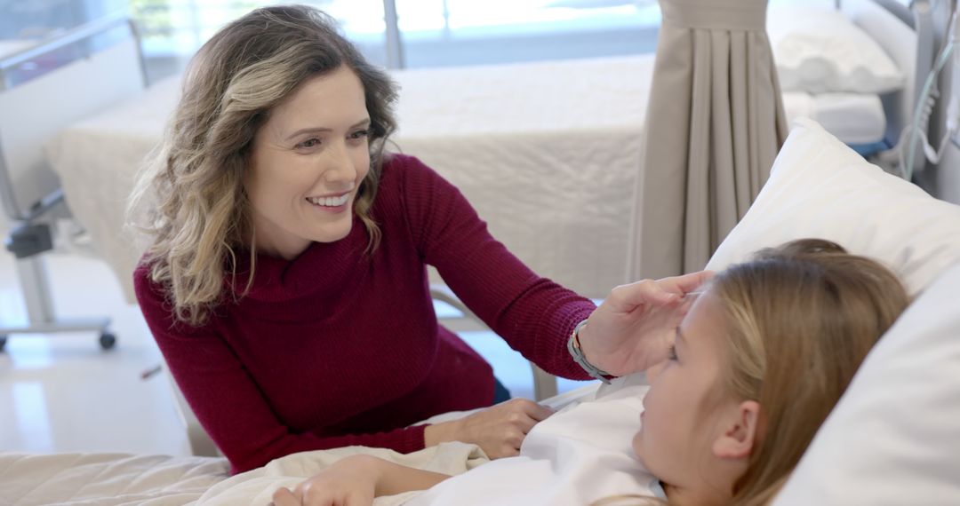 Mother Touching Forehead of Sick Daughter in Hospital Bed - Free Images, Stock Photos and Pictures on Pikwizard.com