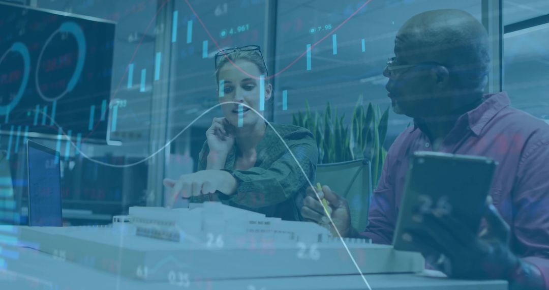 Business Professionals Discussing Chart Analysis with Tablet and Digital Data Overlay