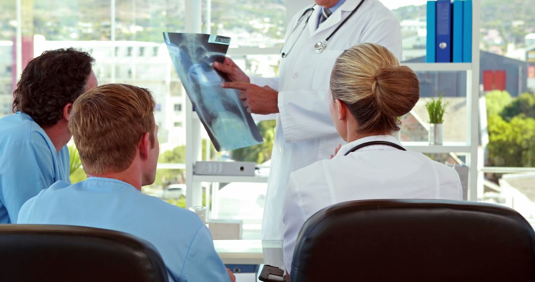 Doctors Reviewing X-ray Image in Medical Meeting - Free Images, Stock Photos and Pictures on Pikwizard.com