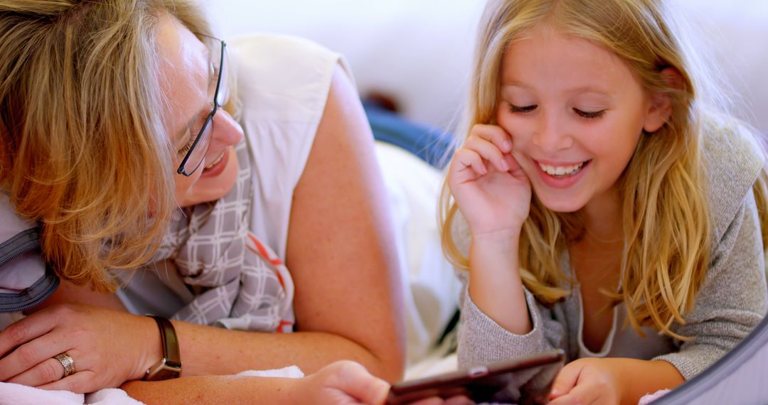 Mother and Daughter Laughing Together Using Tablet - Free Images, Stock Photos and Pictures on Pikwizard.com