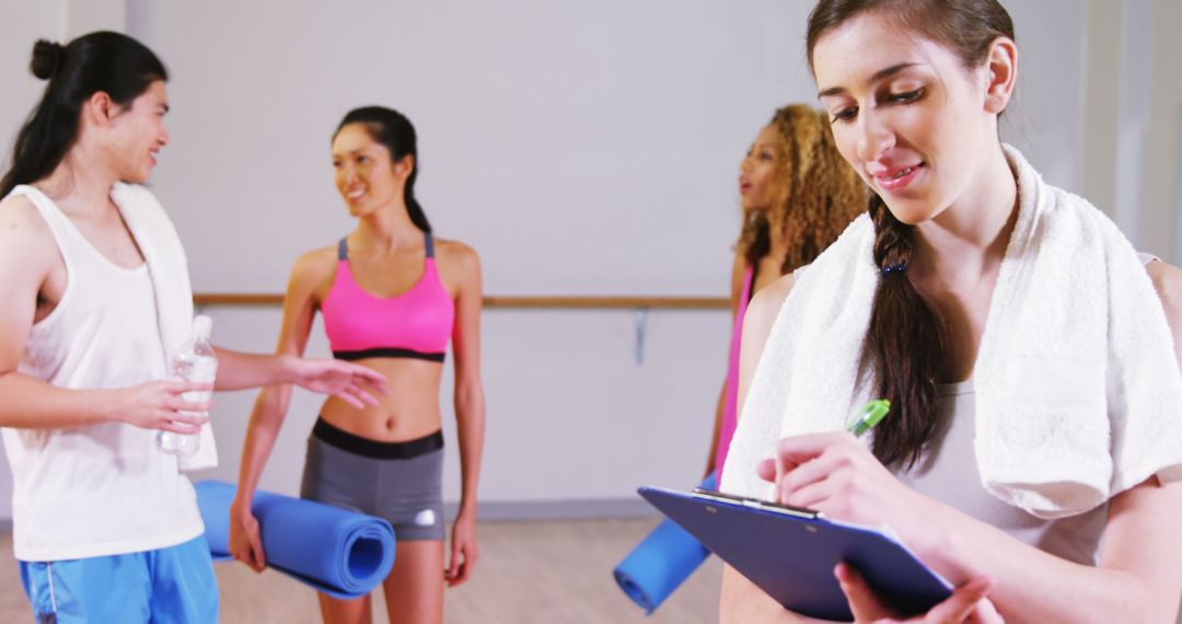 Group of Young Adults in Fitness Studio Discussing Workout Routine - Free Images, Stock Photos and Pictures on Pikwizard.com