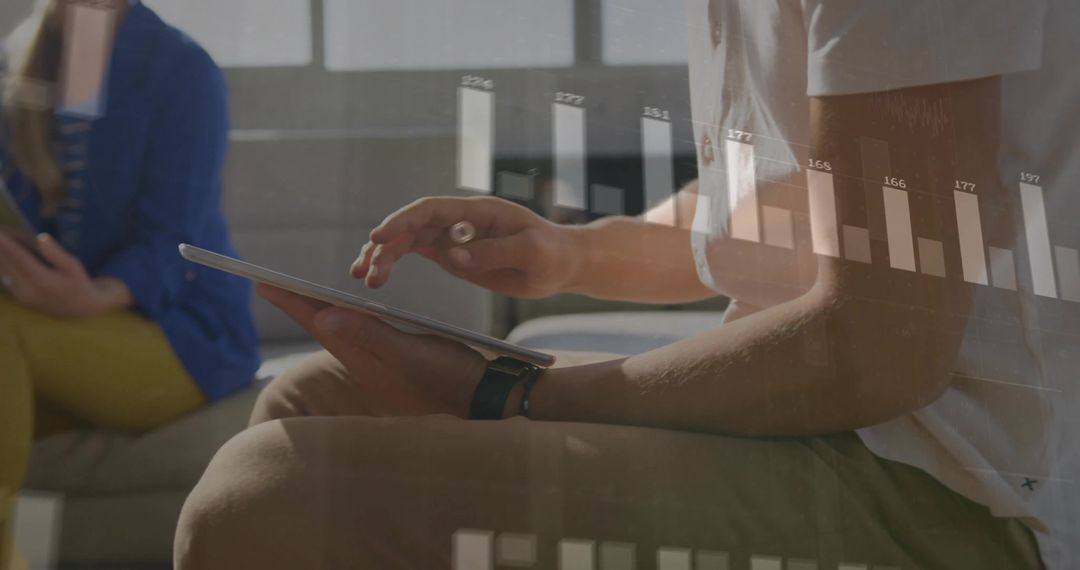 Man Analyzing Digital Data Projection on Tablet in Office Setting