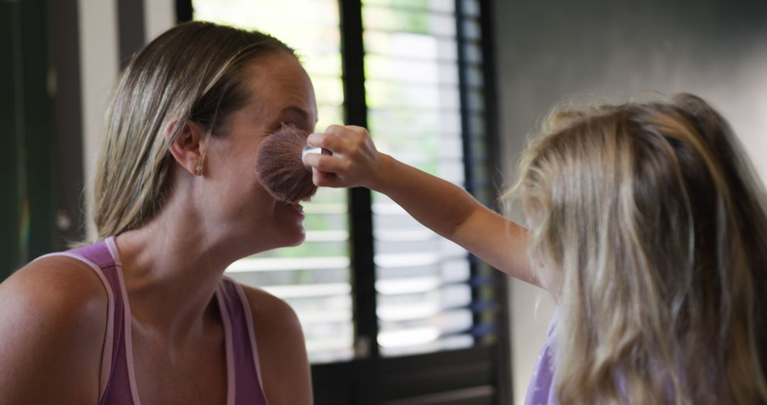 Little Girl Applying Makeup to Mother's Face in Sunlit Room - Free Images, Stock Photos and Pictures on Pikwizard.com