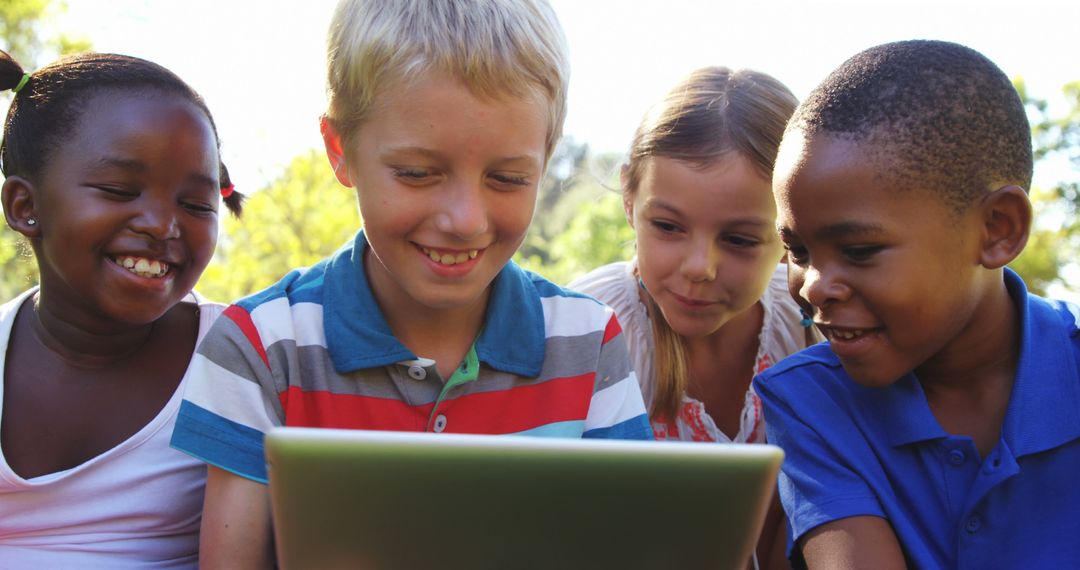 Diverse group of children using tablet outdoors in park - Free Images, Stock Photos and Pictures on Pikwizard.com