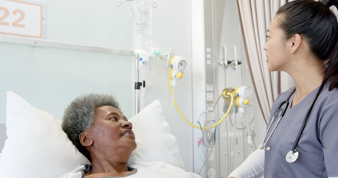 Nurse Assisting Elderly Patient in Hospital Bed with IV Drip - Free Images, Stock Photos and Pictures on Pikwizard.com