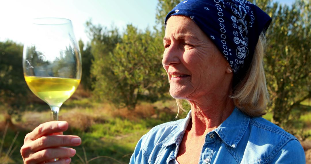 Elderly Woman Enjoying Outdoors with Glass of White Wine - Free Images, Stock Photos and Pictures on Pikwizard.com