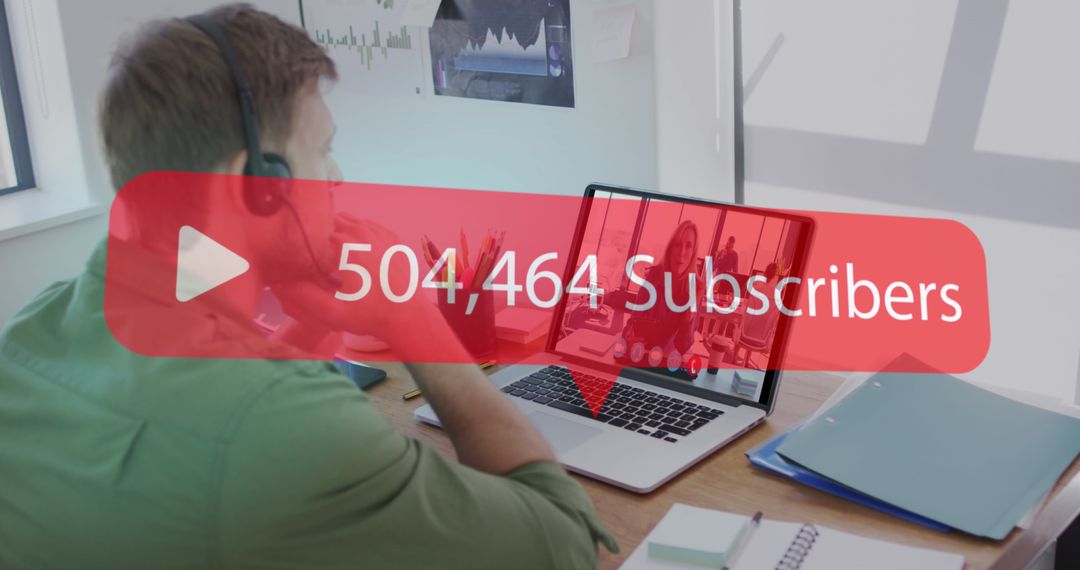 Content Creator Monitoring YouTube Subscriber Growth on Laptop