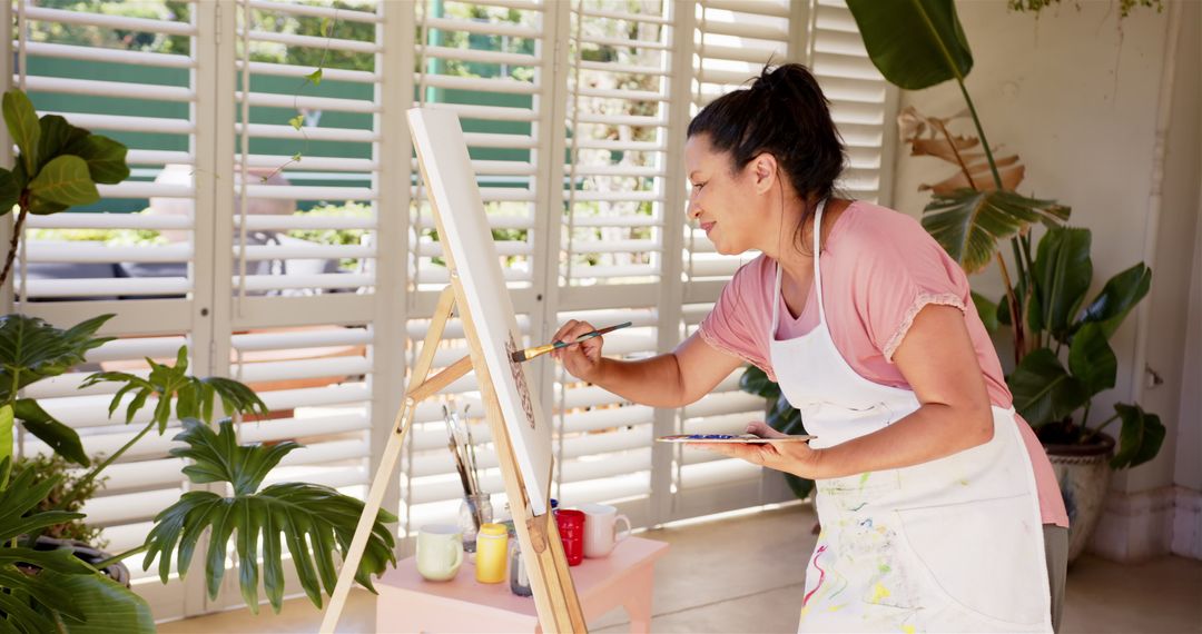 Woman Creating Art in Bright Creative Home Studio
