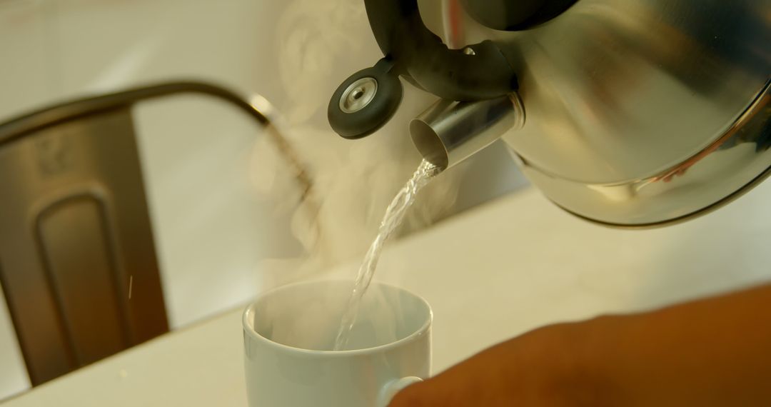 Steam Rising from Kettle Pouring Hot Water into Mug