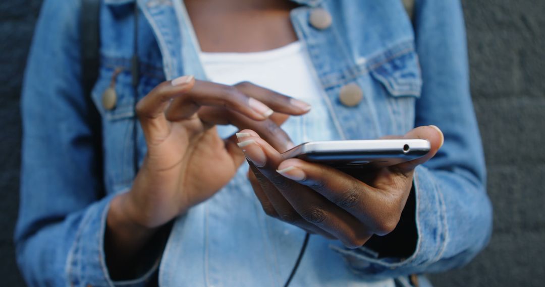 Closeup of Person Texting on Smartphone Outdoors in Denim Jacket - Free Images, Stock Photos and Pictures on Pikwizard.com