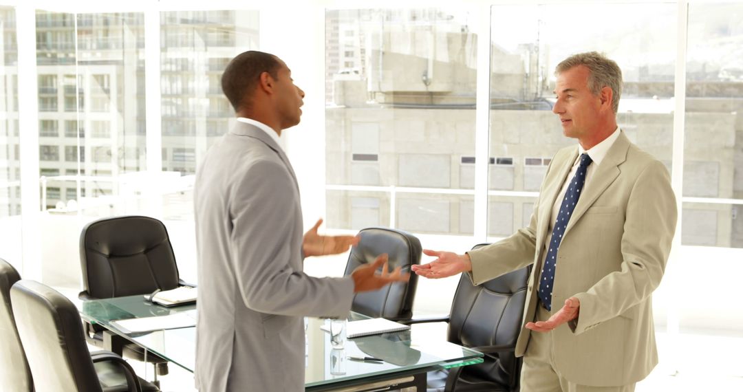 Two Businessmen Discussing in Bright Office Meeting Room - Free Images, Stock Photos and Pictures on Pikwizard.com