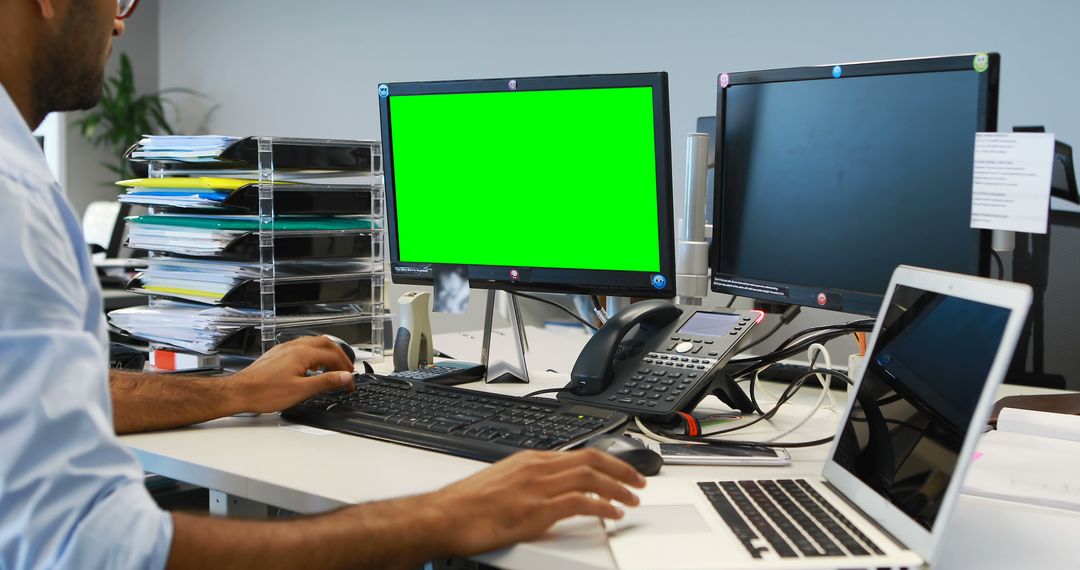 Office Worker on Dual Monitors and Laptop with Green Screen Display - Free Images, Stock Photos and Pictures on Pikwizard.com