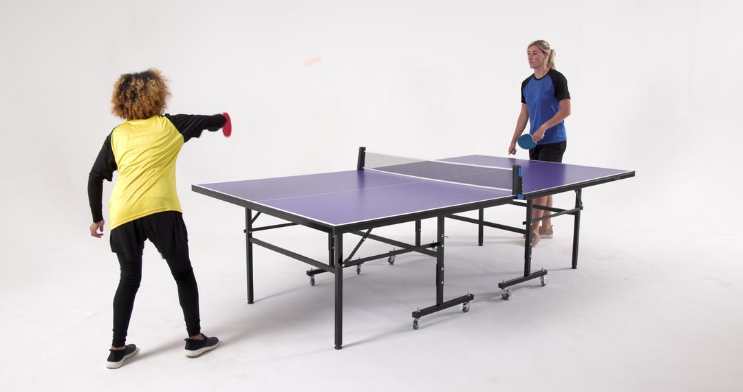 Diverse Female Athletes Playing Ping Pong Enthusiastically