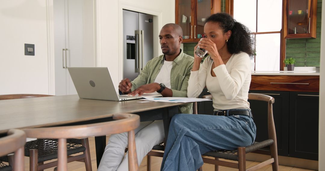 Diverse Couple Collaborating from Home, Electrical and Relaxed