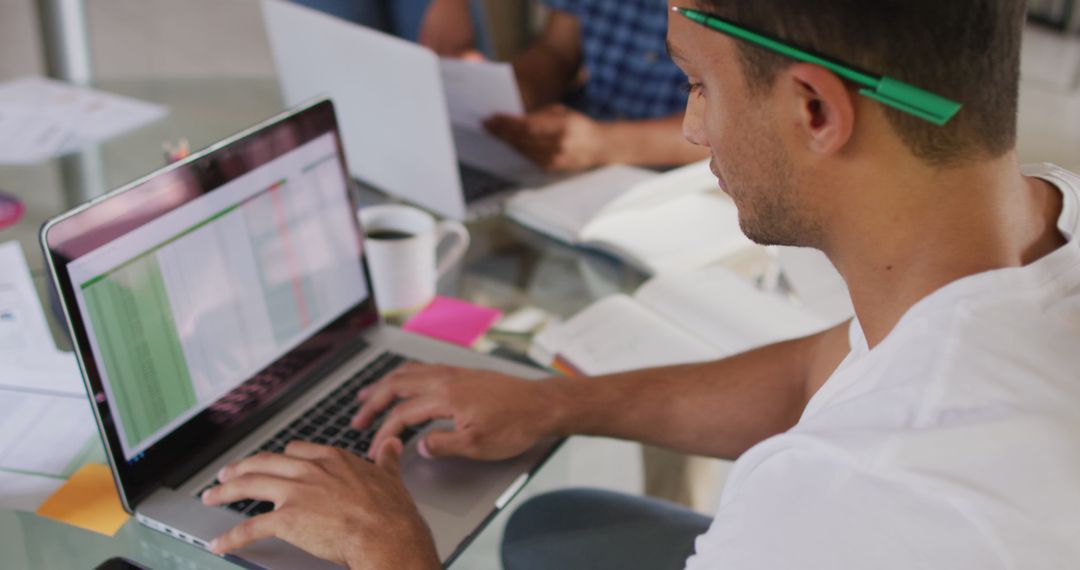 Focused Professional Working on Laptop in Modern Workspace