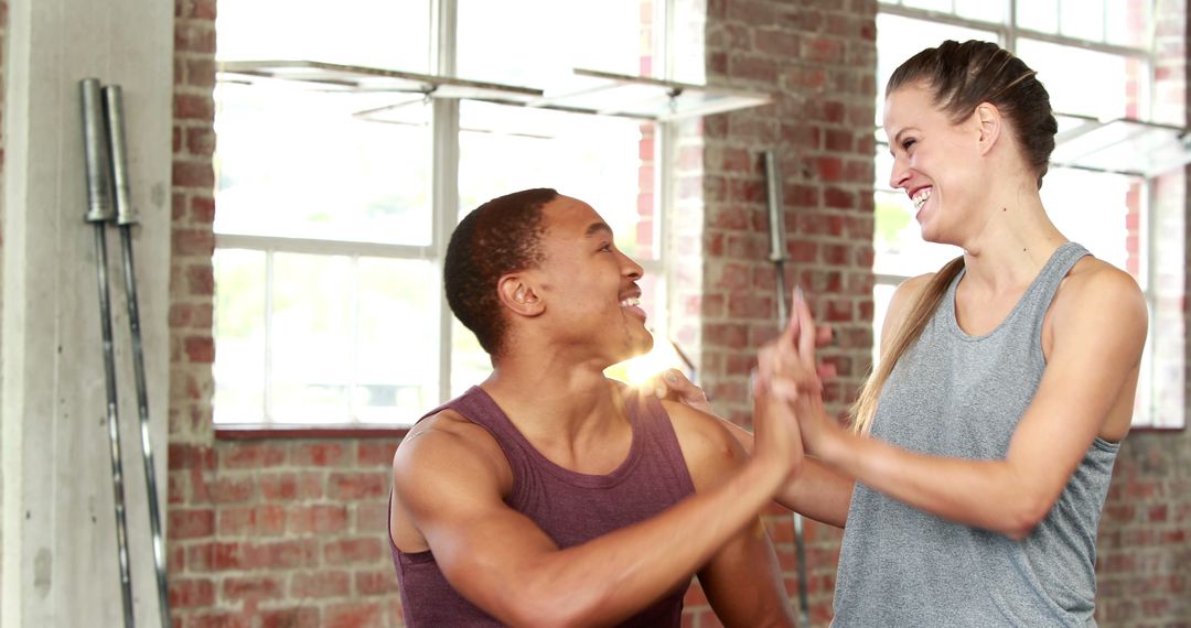 Two athletes sharing high five in urban gym - Free Images, Stock Photos and Pictures on Pikwizard.com