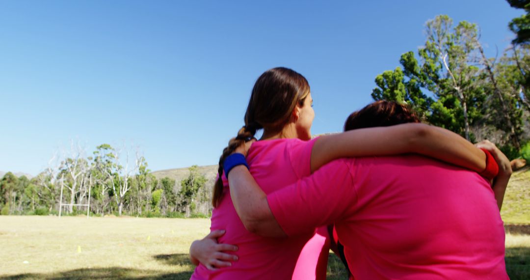 Back View of Women Embracing in Tranquil Park Setting