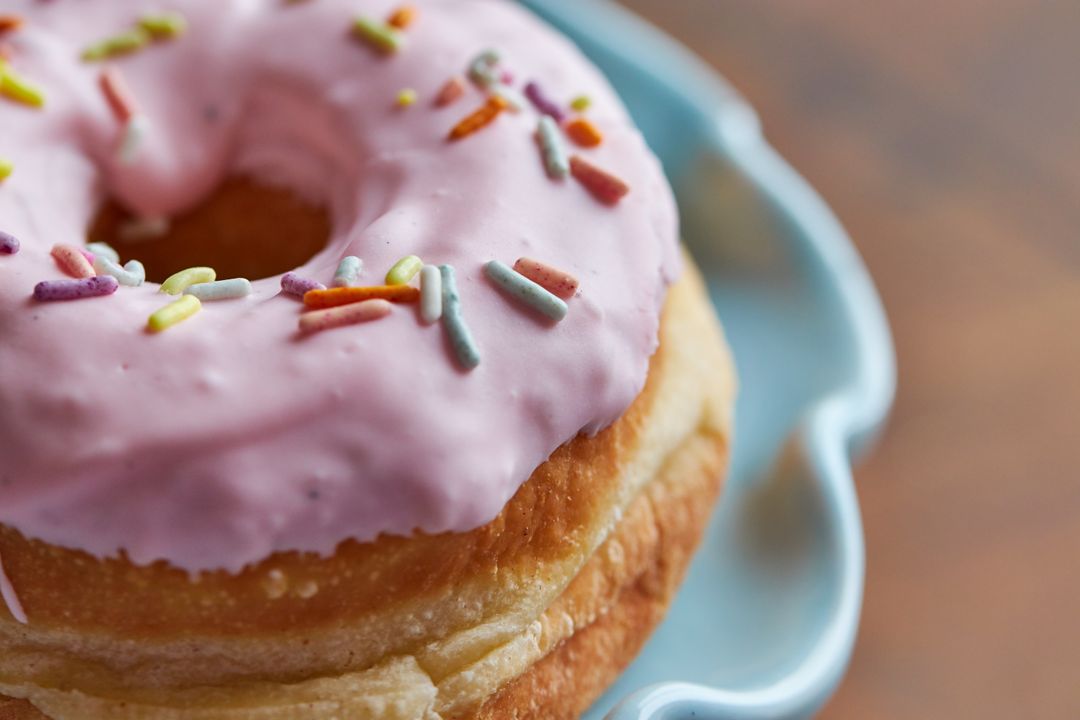 Bright Pink Iced Donut with Colorful Sprinkles
