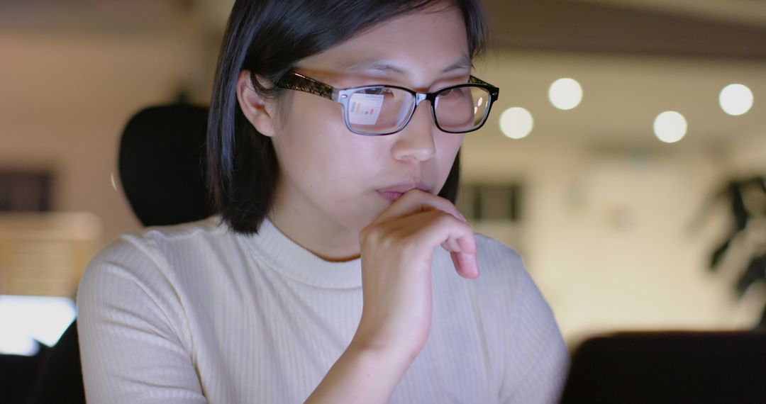 Focused Woman Working Late in Office Environment