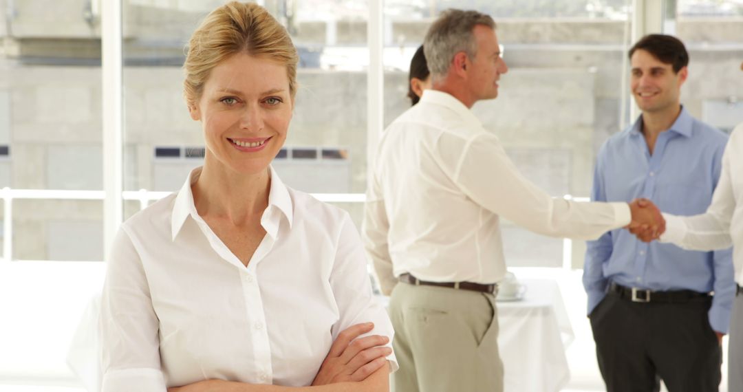 Confident Businesswoman in Office with Colleagues Shaking Hands - Free Images, Stock Photos and Pictures on Pikwizard.com