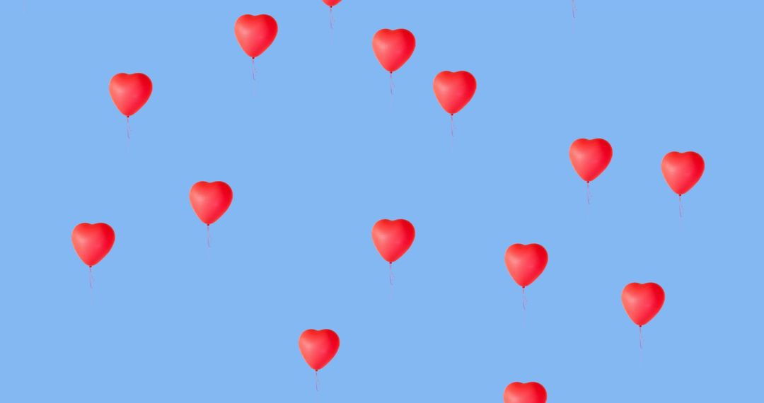 Red Heart Balloons Floating on Blue Background