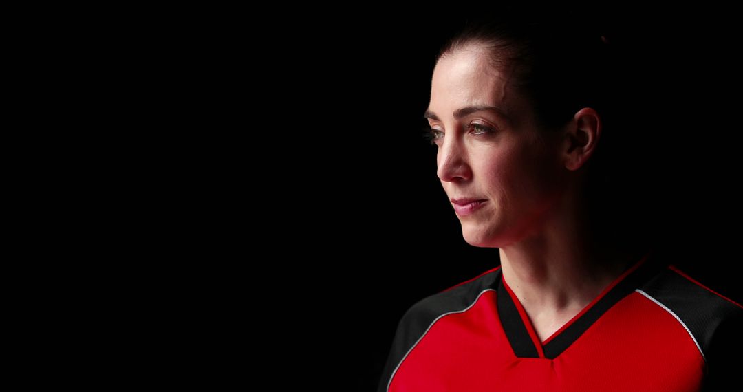 Female Athlete in Red and Black Uniform Against Black Background - Free Images, Stock Photos and Pictures on Pikwizard.com