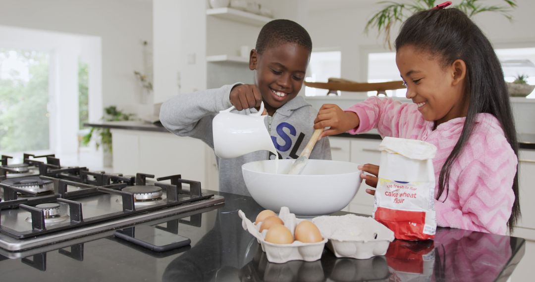 Siblings Baking Together in Modern Kitchen - Free Images, Stock Photos and Pictures on Pikwizard.com