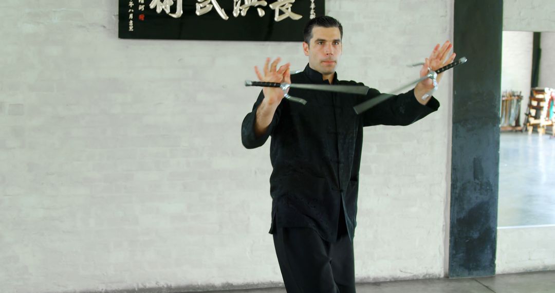 Man Practicing Martial Arts with Nunchaku in Training Hall - Free Images, Stock Photos and Pictures on Pikwizard.com