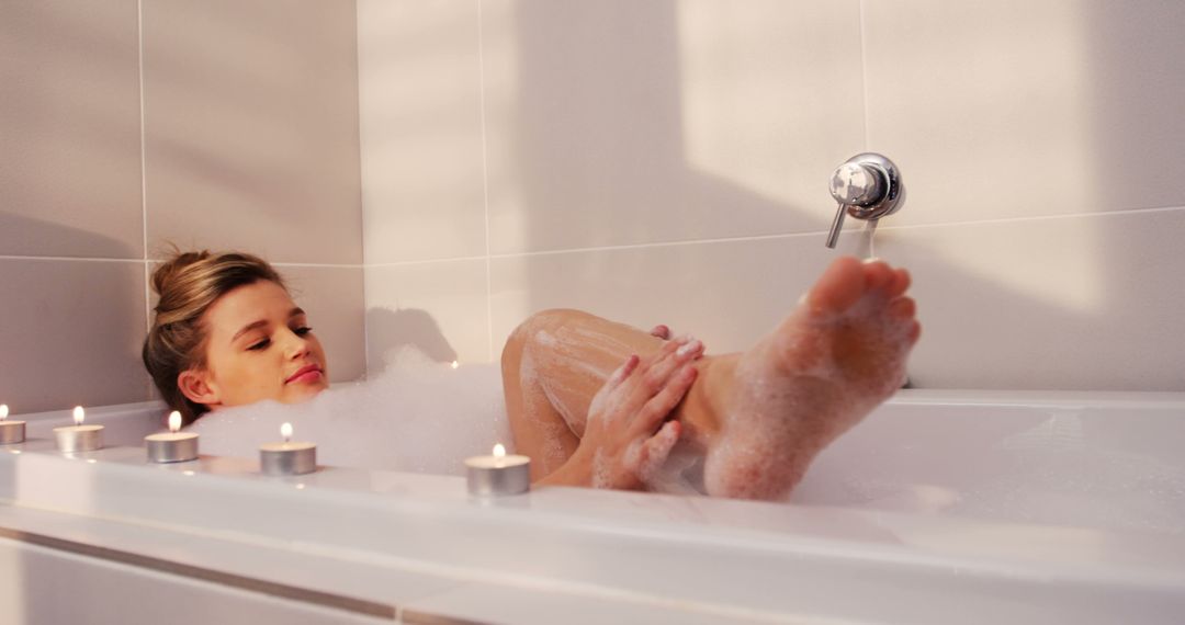 Woman Relaxing in Bathtub Surrounded by Soft Candlelight - Free Images, Stock Photos and Pictures on Pikwizard.com