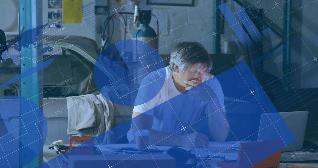 Engineer Reviewing Blueprints in Workshop Setting