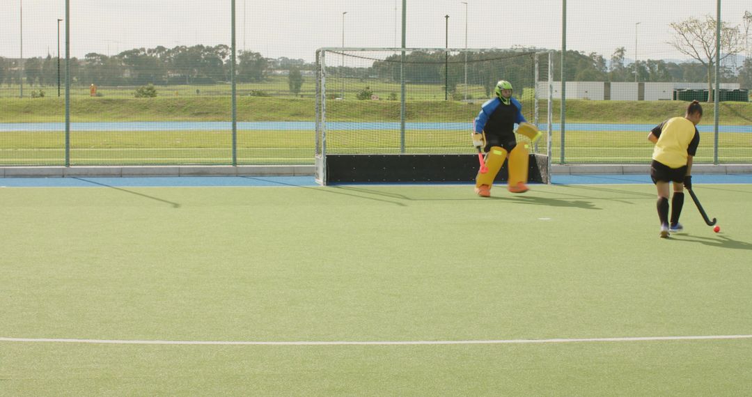Female Field Hockey Players Defending and Attacking on Turf
