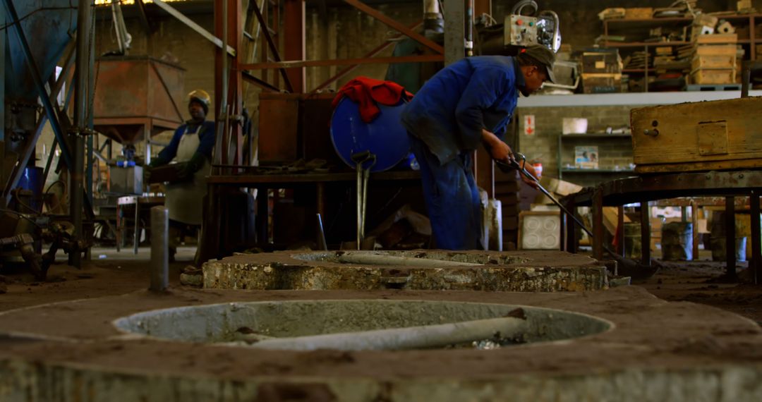 Factory Workers Operating Heavy Machinery in Industrial Workshop - Free Images, Stock Photos and Pictures on Pikwizard.com