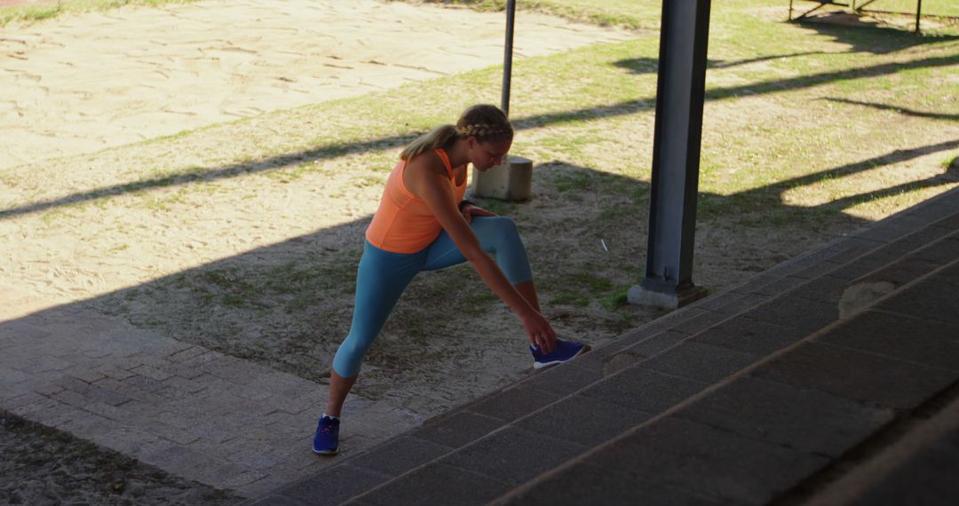 Woman Stretching Outdoors Near Stairs in Bright Workout Clothes - Free Images, Stock Photos and Pictures on Pikwizard.com